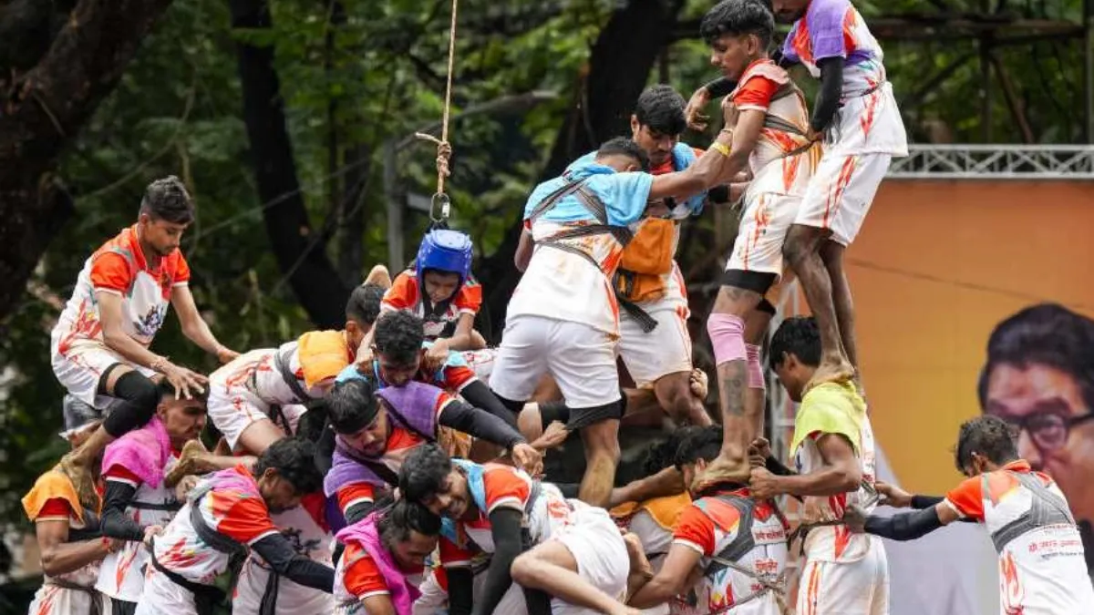 'Govindas' form a human pyramid to break the 'Dahi Handi' on the occasion of ‘Janmashtami’ festival, in Thane, Saturday. 