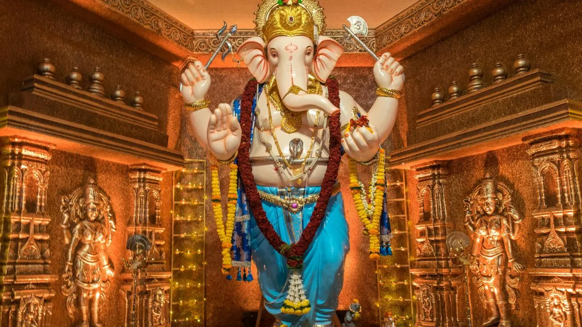 A grand Ganesh idol decorated with flowers and lights during Ganesh Chaturthi celebrations.