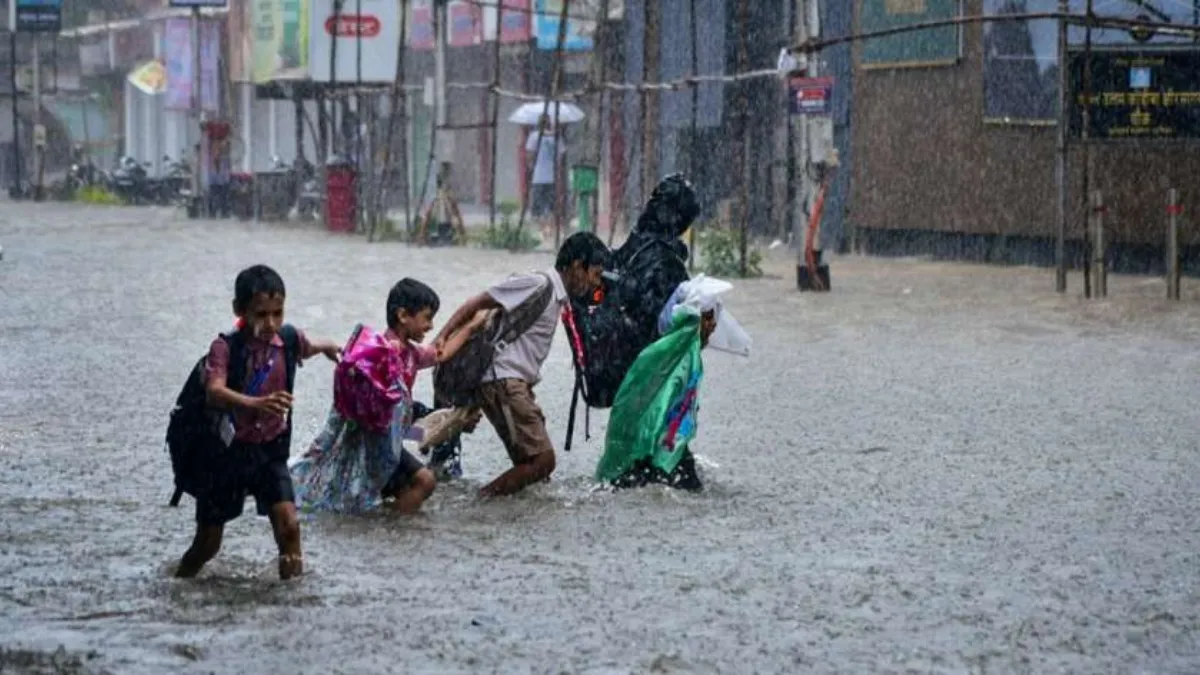 Children waded through waterlogged roads in Mumbai as heavy rainfall led to school closures, traffic jams, and flooding across several areas.