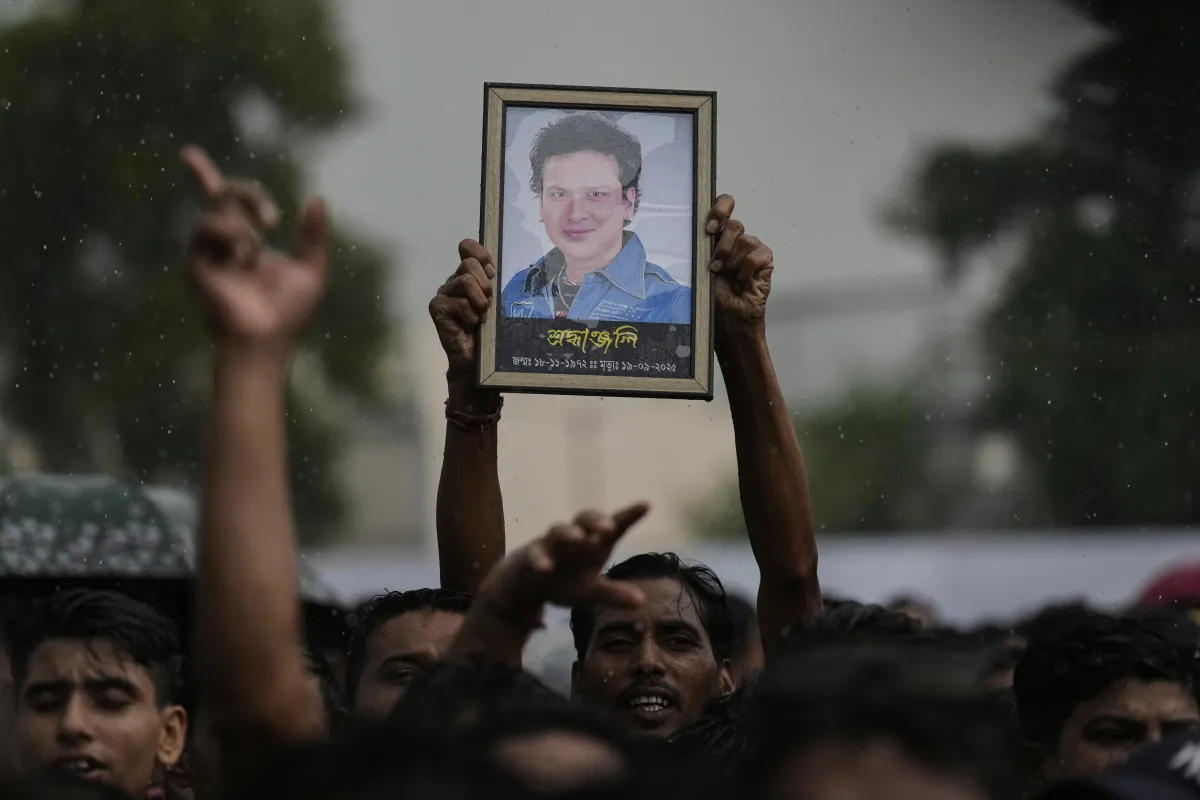 Fans hold a photo of Zubeen Garg.