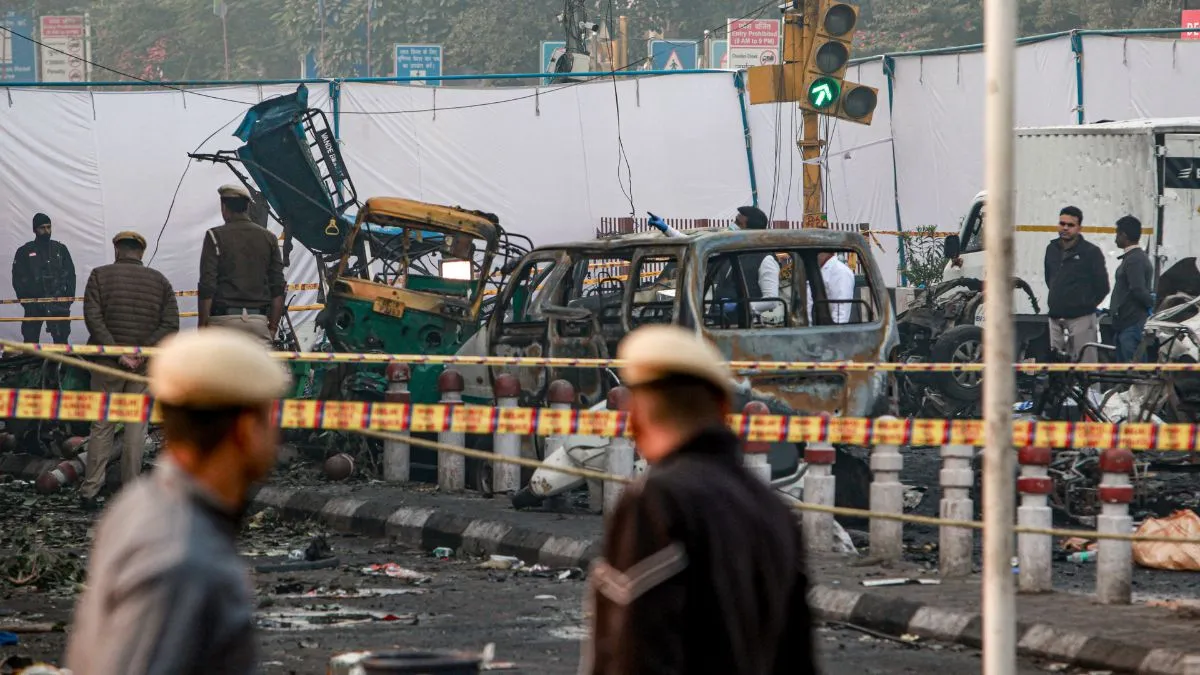 Charred remains of vehicles at a cordoned off area following a blast that occurred near Red Fort Metro Station on Monday. Delhi blast