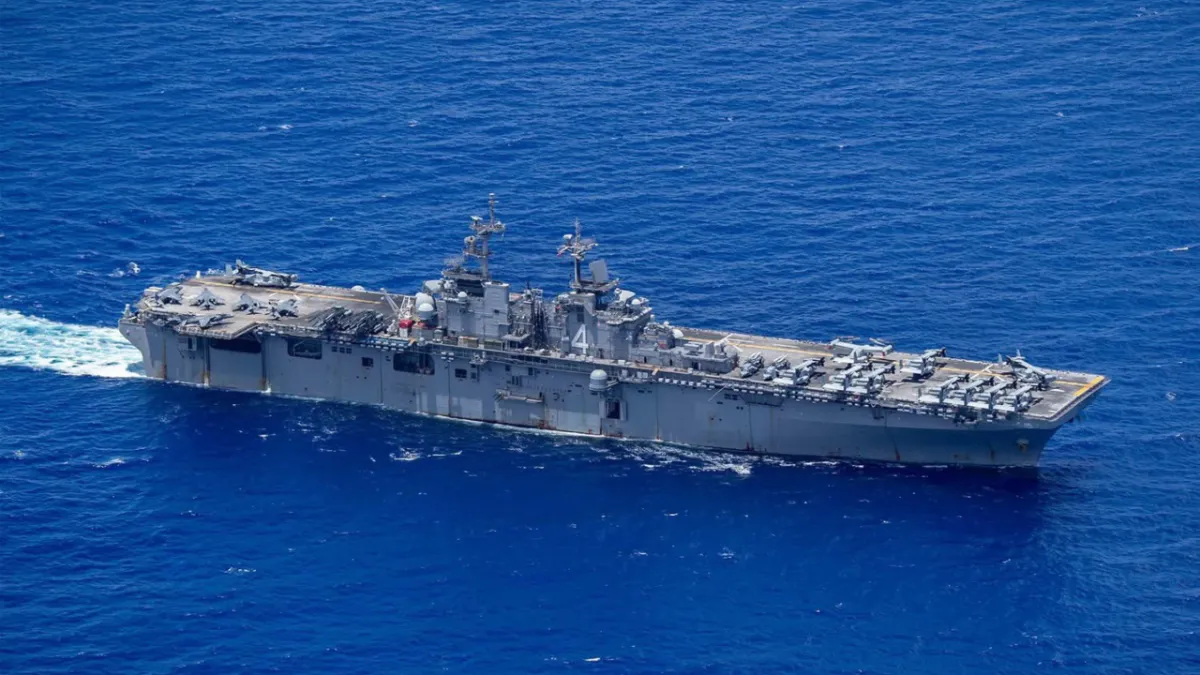 USS Tripoli amphibious assault ship sailing toward the Strait of Hormuz carrying Marines for the Iran crisis in March 2026