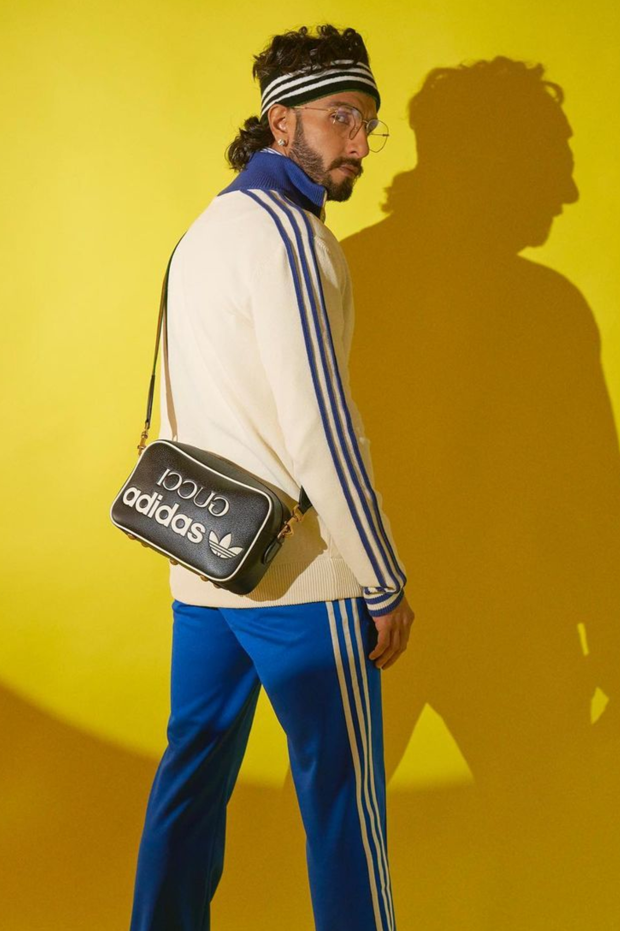 Looking all sporty, Ranveer Singh was styled in a blue and white jogger and upper. He completed his look with specs, and a headband and also carried a side sling bag.