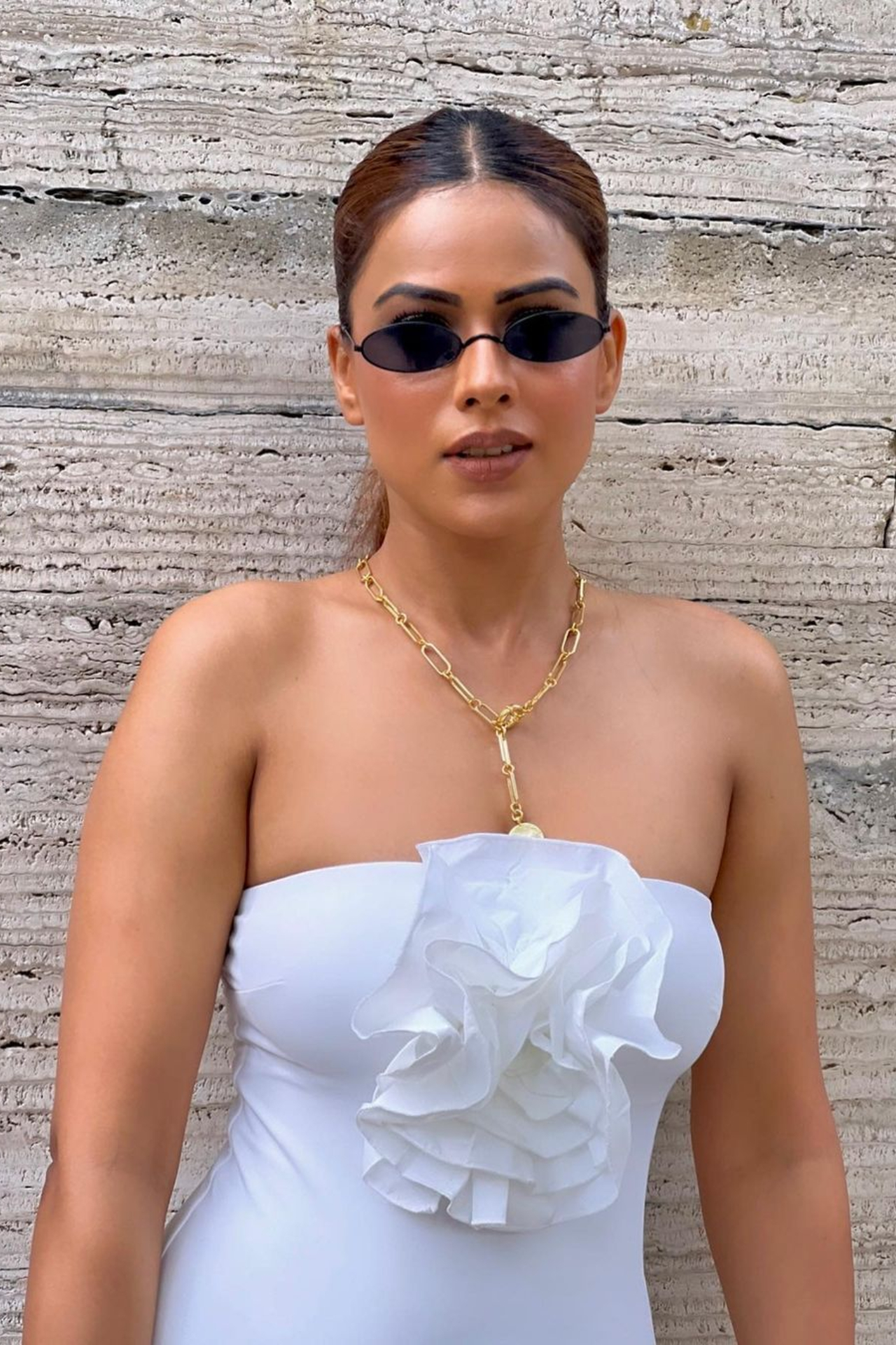 Nia looks ravishing in the white off-shoulder outfit. She finished her look with a pair of black cat-eye sunglasses.