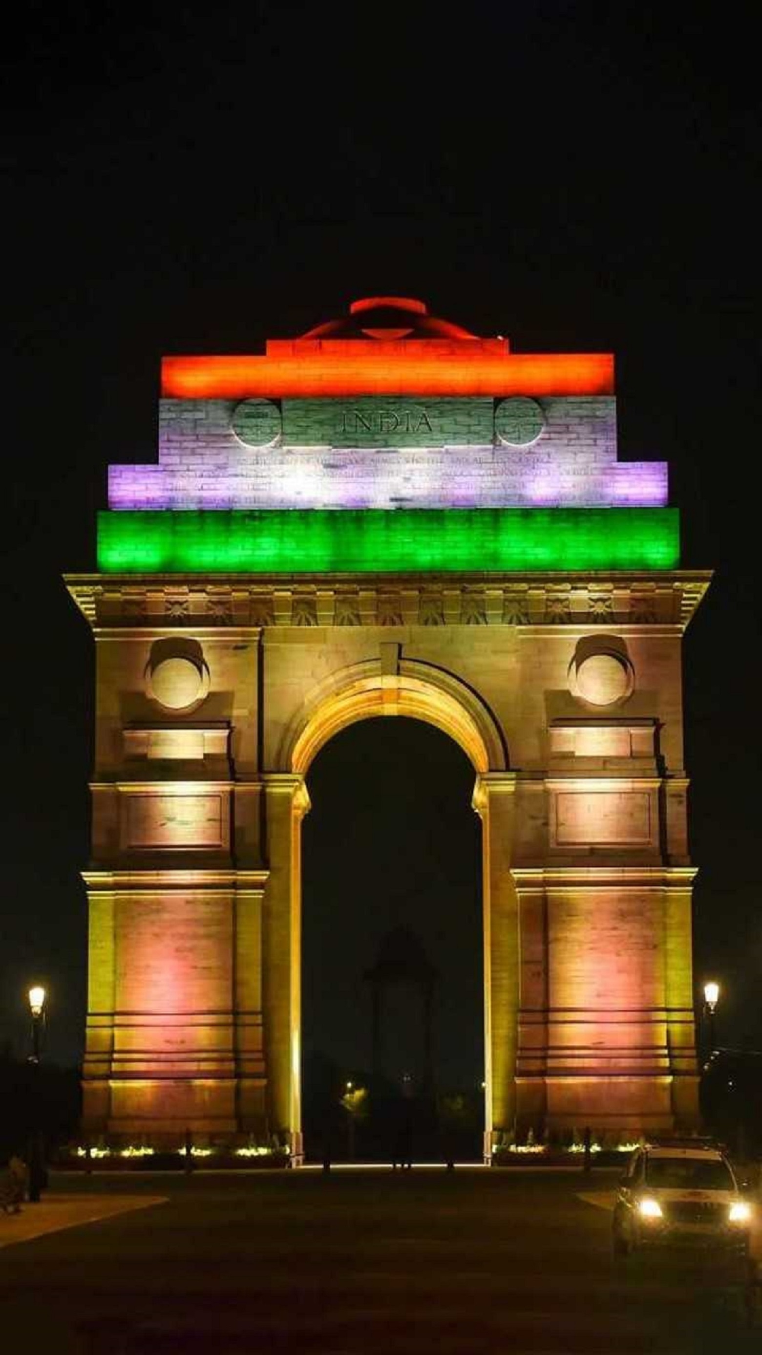 New Delhi: People visit the India Gate, illuminated with tricolour lights