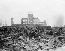 An allied correspondent stands in the rubble