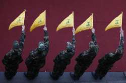 Hezbollah fighters hold flags