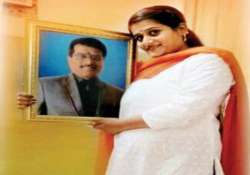 Daughter posing with the picture of her father