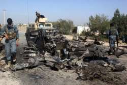 Afghan security forces inspect site of a US airstrike in Kunduz city Oct 2, 2015