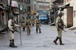 CRPF jawans patrolling a street during restrictions and strike in Srinagar 