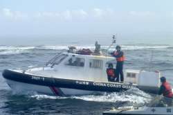 A Chinese Coast Guard boat approaches Filipino fishermen in South China Sea