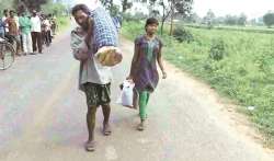 Dana Majhi carrying his dead wife on shoulders