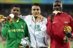 Abdellatif Baka centre shows off his gold medal alongside Tamiru Demisse left)