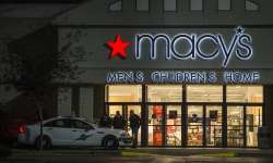 Officers stand outside to the entrance of Macy's at Washington's Cascade mall