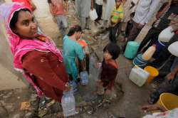 Pakistani residents collecting water