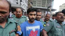 Bangladeshi policemen escort University of Toronto student Tahmid Hasib Khan