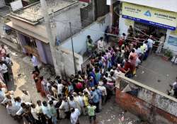 People queue up outside an ATM in Patna