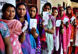 File pic - Women show their voting slips as they wait to cast their votes