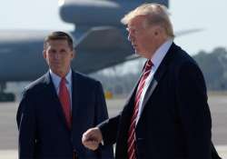 Trump passes former NSA Michael Flynn as he arrives via Air Force One