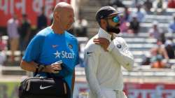 Virat Kohli walks off the field after suffering shoulder injury