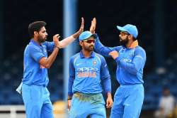 Bhuvneshwar Kumar celebrates with teammate Ajinkya Rahane and captain Kohli