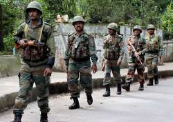 Army personnel patrol a street in Darjeeling