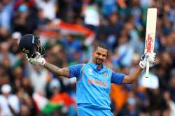 Shikhar Dhawan raises his bat after his hundred.