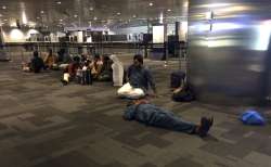 Passengers of cancelled flights wait at Doha Airport