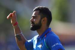 Virat Kohli of India celebrates as he leaves the field 