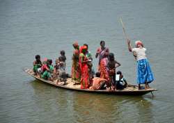 Flood affected people travel to a makeshift camp at Goroimari village in Kamrup