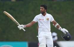 Dinesh Chandimal raises his bat to acknowledge the crowd