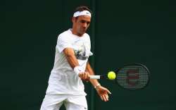 Roger Federer of Switzerland plays a backhand during practice session