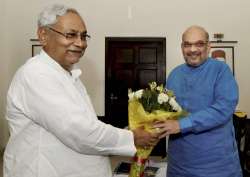 Nitish Kumar greets Amit Shah in a meeting at the latter's residence