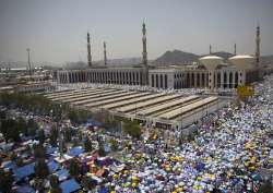 Muslim pilgrims attend noon prayers outside the Namirah mosque in Mecca