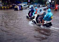 Vehicles wade through a flooded road after heavy rains in Vashi on Tuesday 