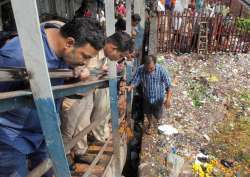 People look on at stampede site that broke out on Elpistion Railway Station 