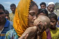 A Rohingya Muslim woman kisses her infant son. Ph