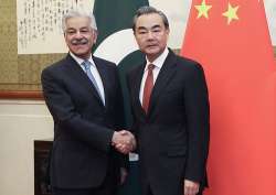 Wang Yi shakes hands with Khawaja Asif at Diaoyutai State Guesthouse in Beijing