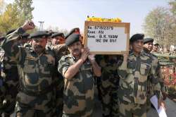 BSF personnel carrying the coffin containing the body of BK Yadav