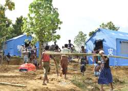 File pic - People walk near Chinese relief tents at a camp in Cox's Bazaar district, Bangladesh