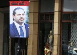 A poster of resigned Lebanese PM Saad Hariri with Arabic that read, “We are all with you,” hangs on a street in Beirut