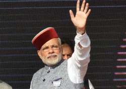 PM Narendra Modi waves at crowd during BJP Parivartan Rally at Rait near Dharamsala