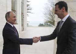 Vladimir Putin shakes hand with Bashar Assad in the Bocharov Ruchei residence in the Black Sea resort of Sochi