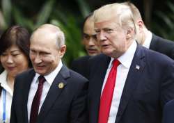 Donald Trump and Vladimir Putin talk during the family photo session at the APEC Summit in Danang