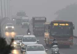 File pic - Vehicles plying at a road in smog in New Delhi