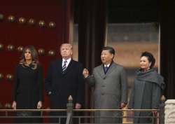 Donald Trump, first lady Melania Trump, Xi Jinping and his wife Peng Liyuan stand together as they tour the Forbidden City