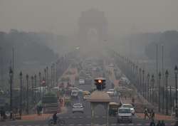  Vehicles ply at Rajpath as a thick smog engulfs India Gate in New Delhi on Monday