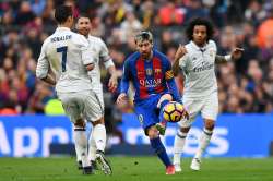 Messi dribbles past Ronaldo in the El Clasico.