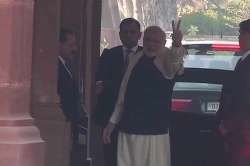 PM Narendra Modi flashes a victory sign as BJP takes unassailable lead in Gujarat.