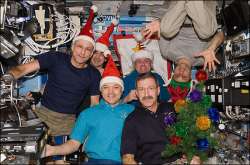 The six Expedition 30 crew members assemble in the U.S. Lab (Destiny) aboard the International Space Station for a brief celebration of the Christmas holiday on Dec. 25, 2011. 